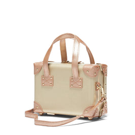 Angled product view of the mini Alchemist vegan leather suitcase in gold with shoulder attachment strap