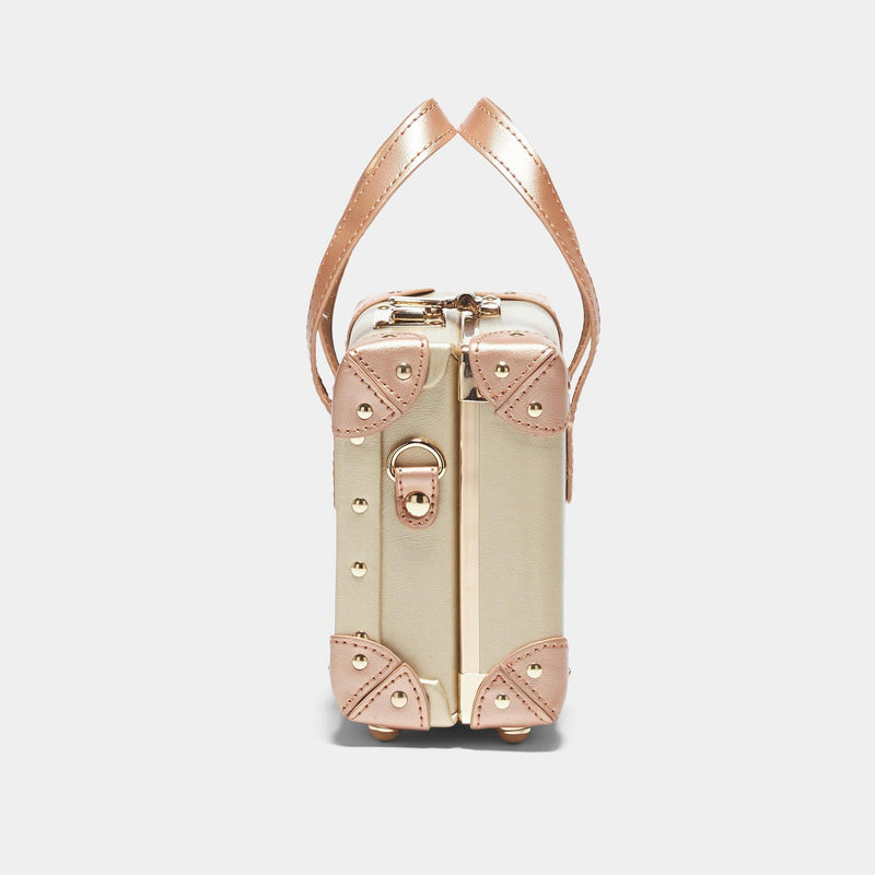 Side view of the mini Alchemist vegan leather suitcase in gold