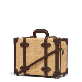 Angled product view of the overnighter Explorer rattan suitcase in  natural wicker body and brown trims
