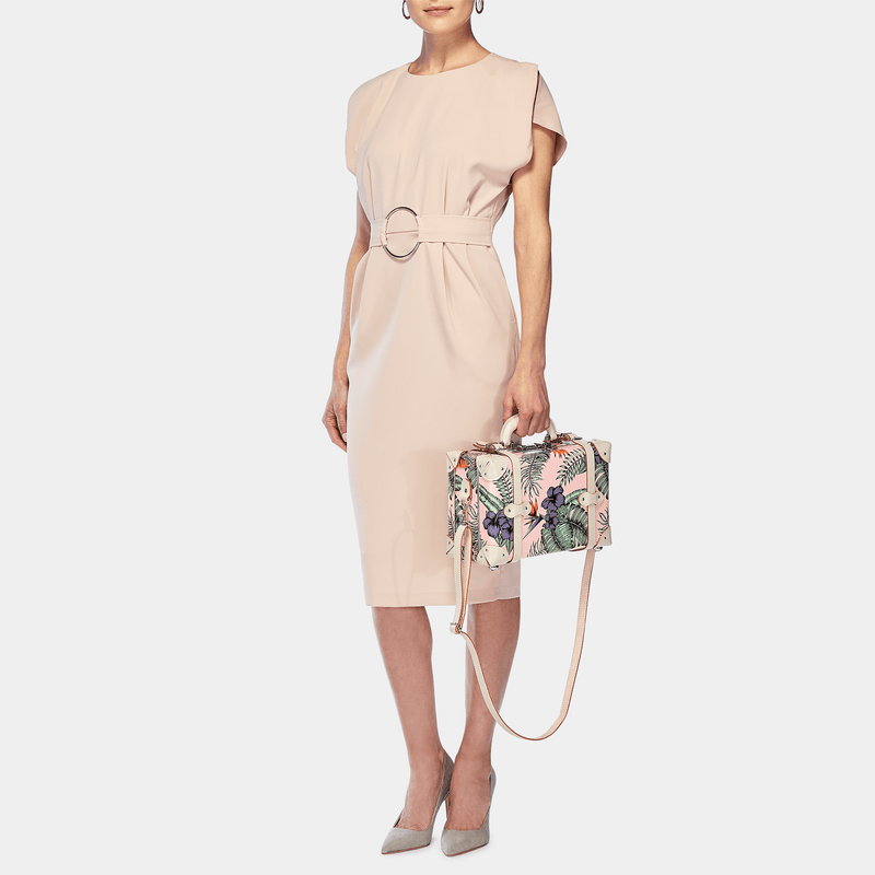 Model with the vanity Botanist fibreboard suitcase in pink with shoulder attachment strap