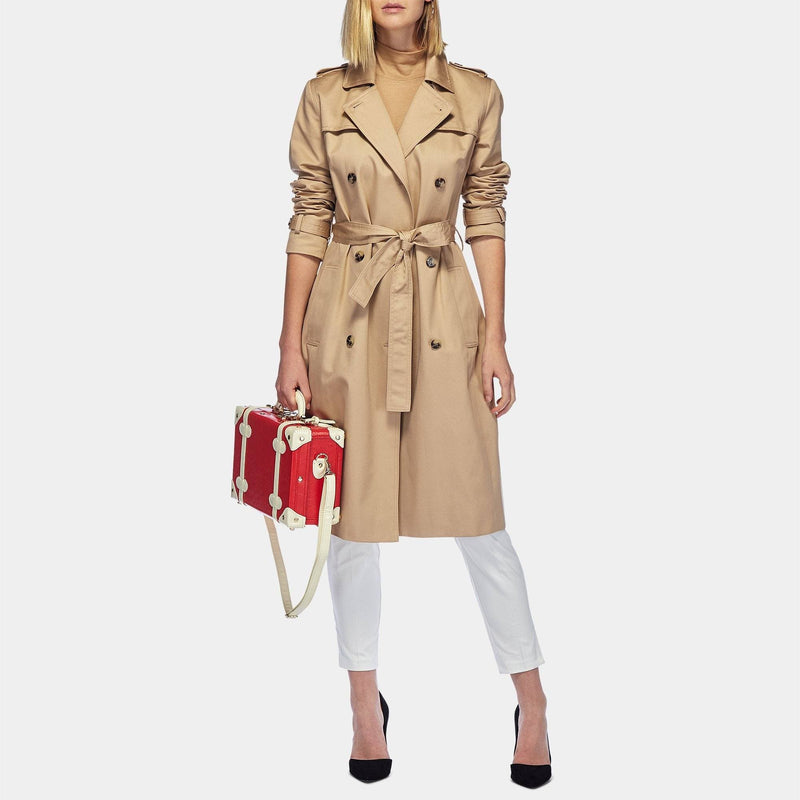 Model with the vanity Entrepreneur vegan leather suitcase in lipstick red with shoulder attachment strap