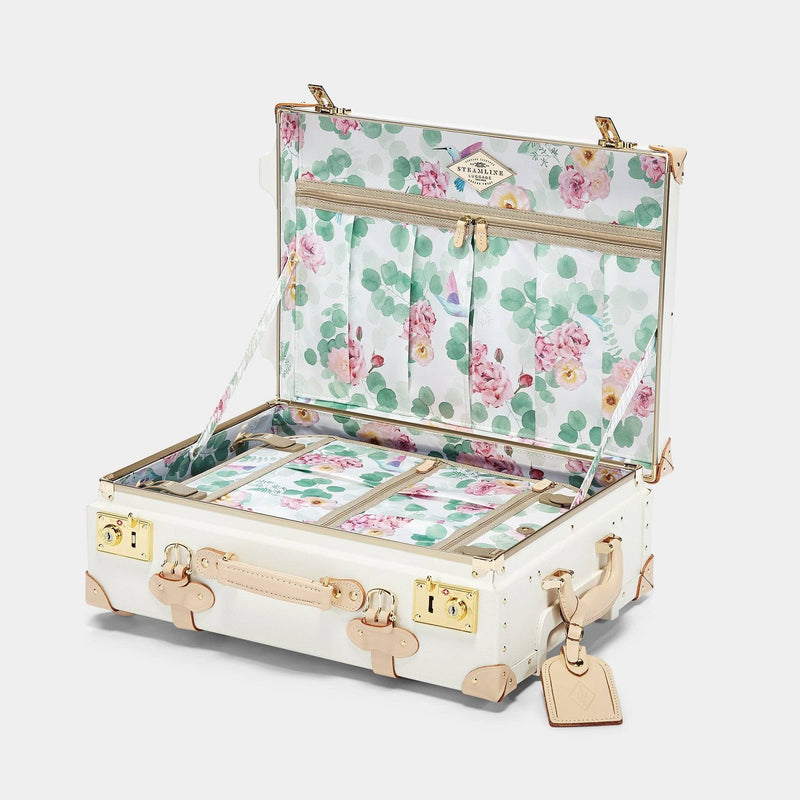 Open product view of the carry-on Sweetheart fibreboard suitcase in cream with botanical printed lining