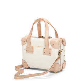 Angled product view of the mini Sweetheart fibreboard suitcase in cream with shoulder attachment strap