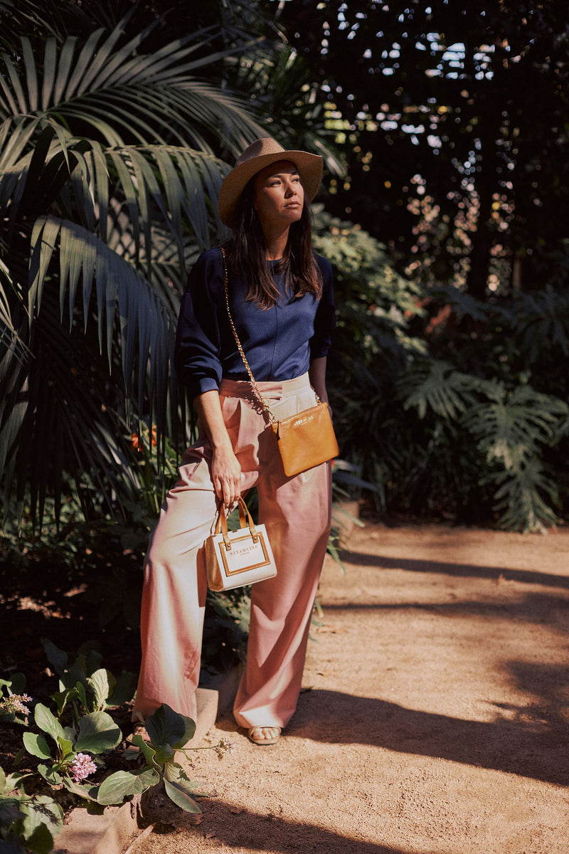 Lifestyle image of model with the Navigator handbags in nut brown