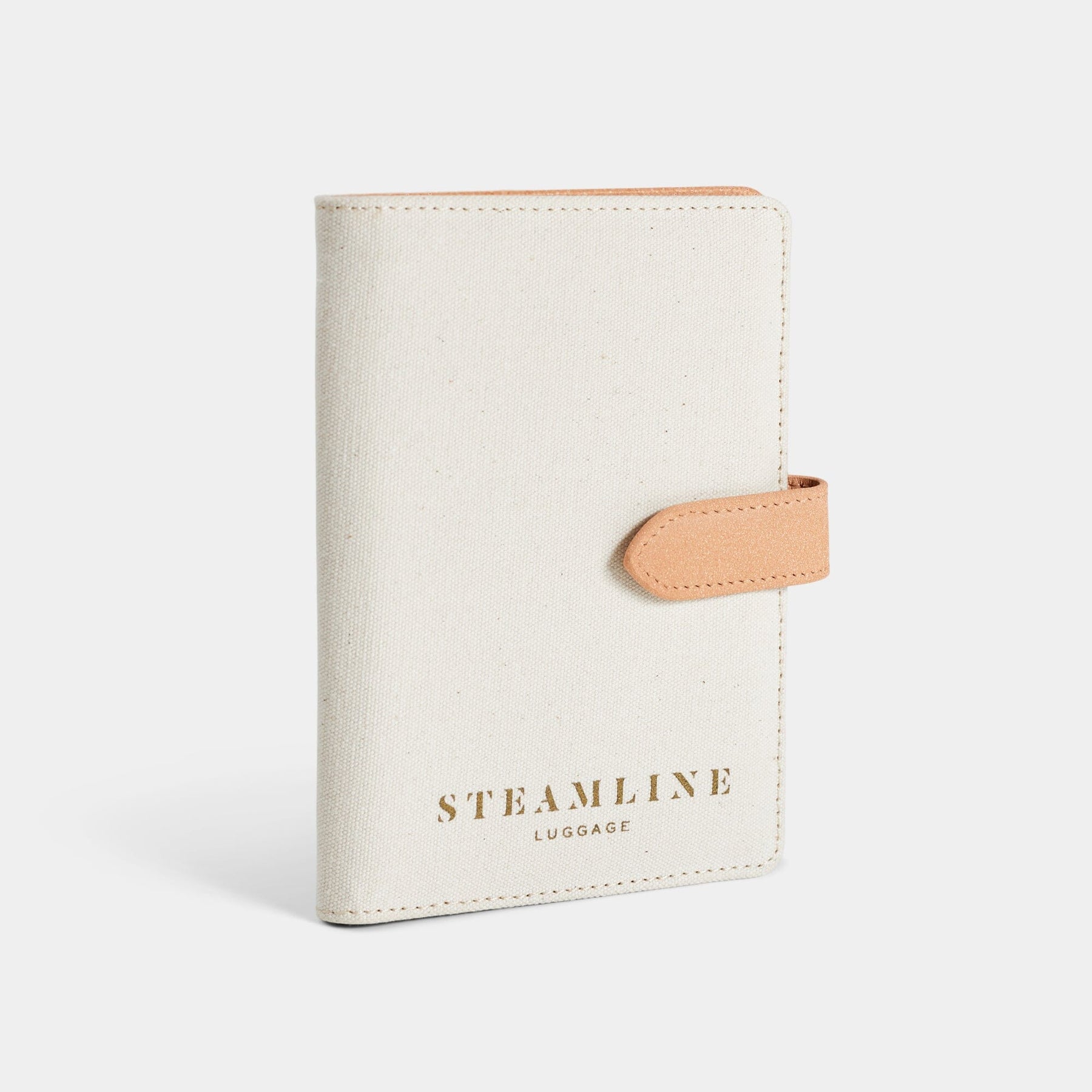 Angled view of the Navigator leather passport holder in white with desert glitter trim and logo