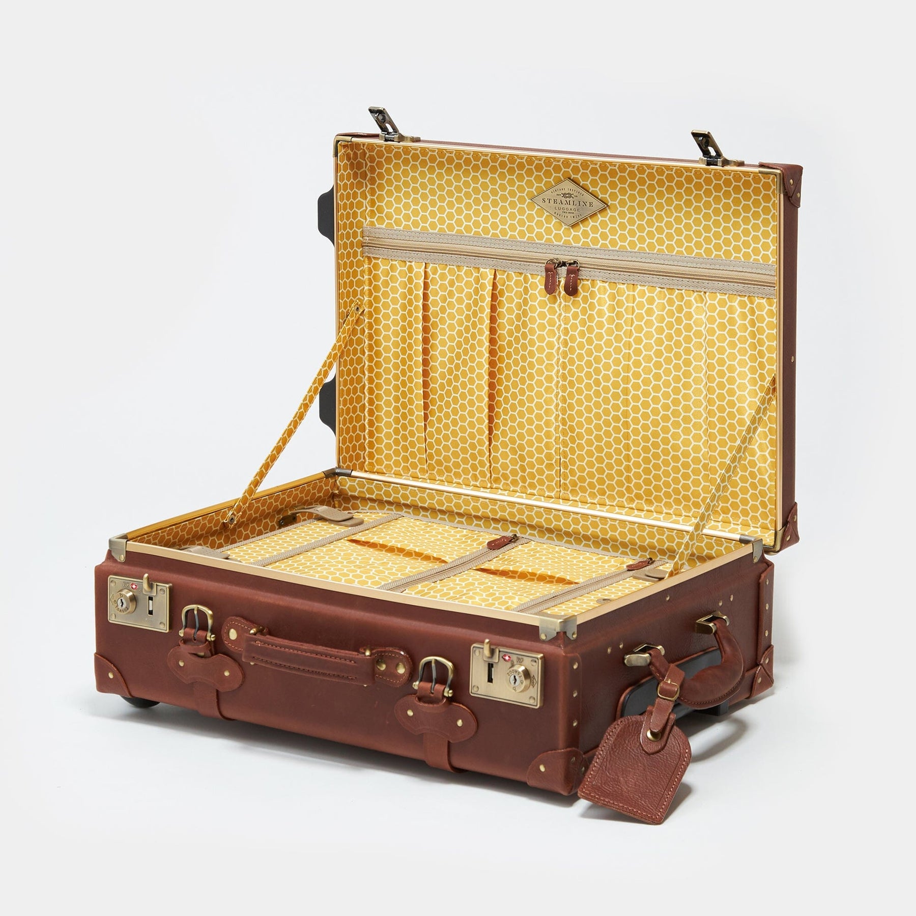 Open product view of the stowaway Pioneer leather suitcase in brown with honeycomb printed lining