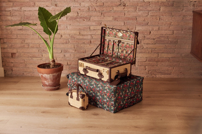 Lifestyle image of the Explorer rattan suitcases in natural wicker body and brown trims