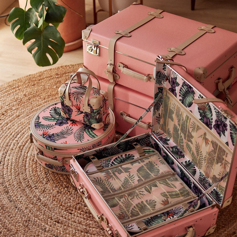 Lifestyle image of Steamline's set of The Botanist fibreboard suitcase in pink