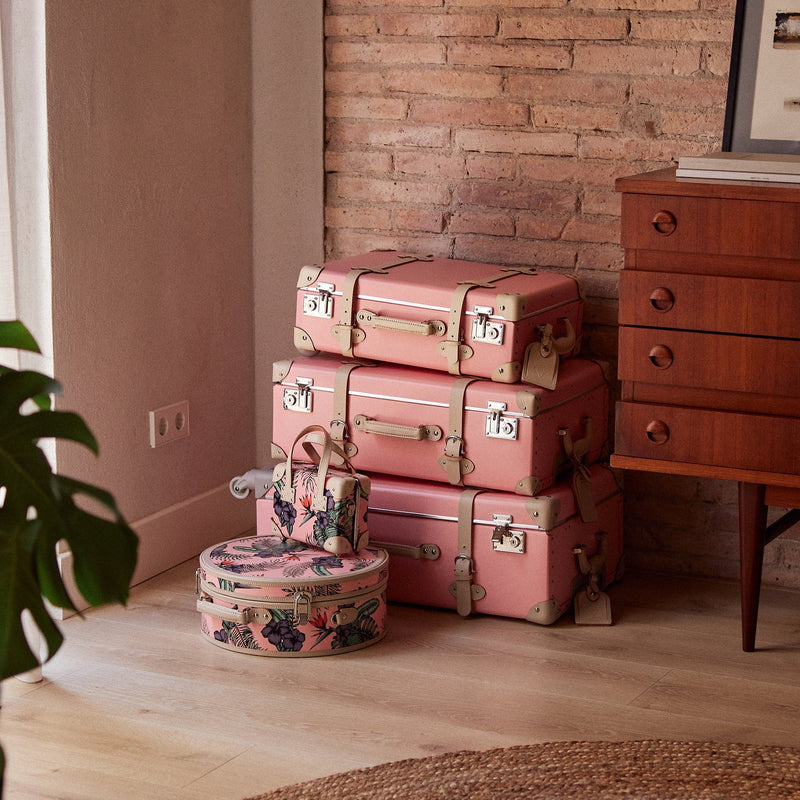 Lifestyle image of Steamline retro luggage set of The Botanist fibreboard suitcase in pink