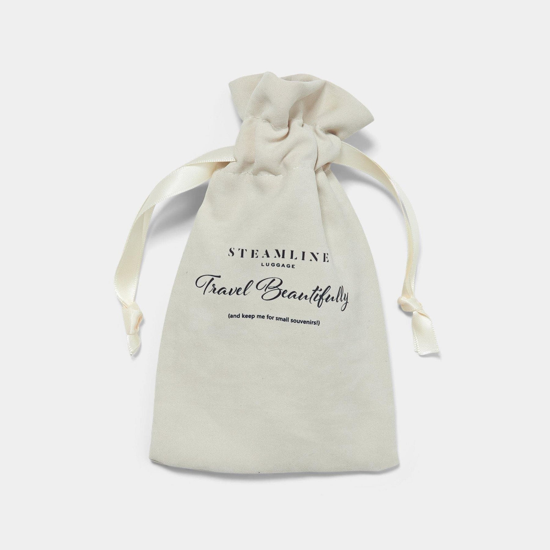 british brown leather luggage tag in cream dustbag