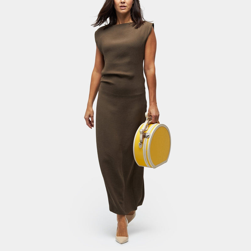 Model with the small hatbox Correspondent fibreboard suitcase in canary yellow with shoulder attachment strap