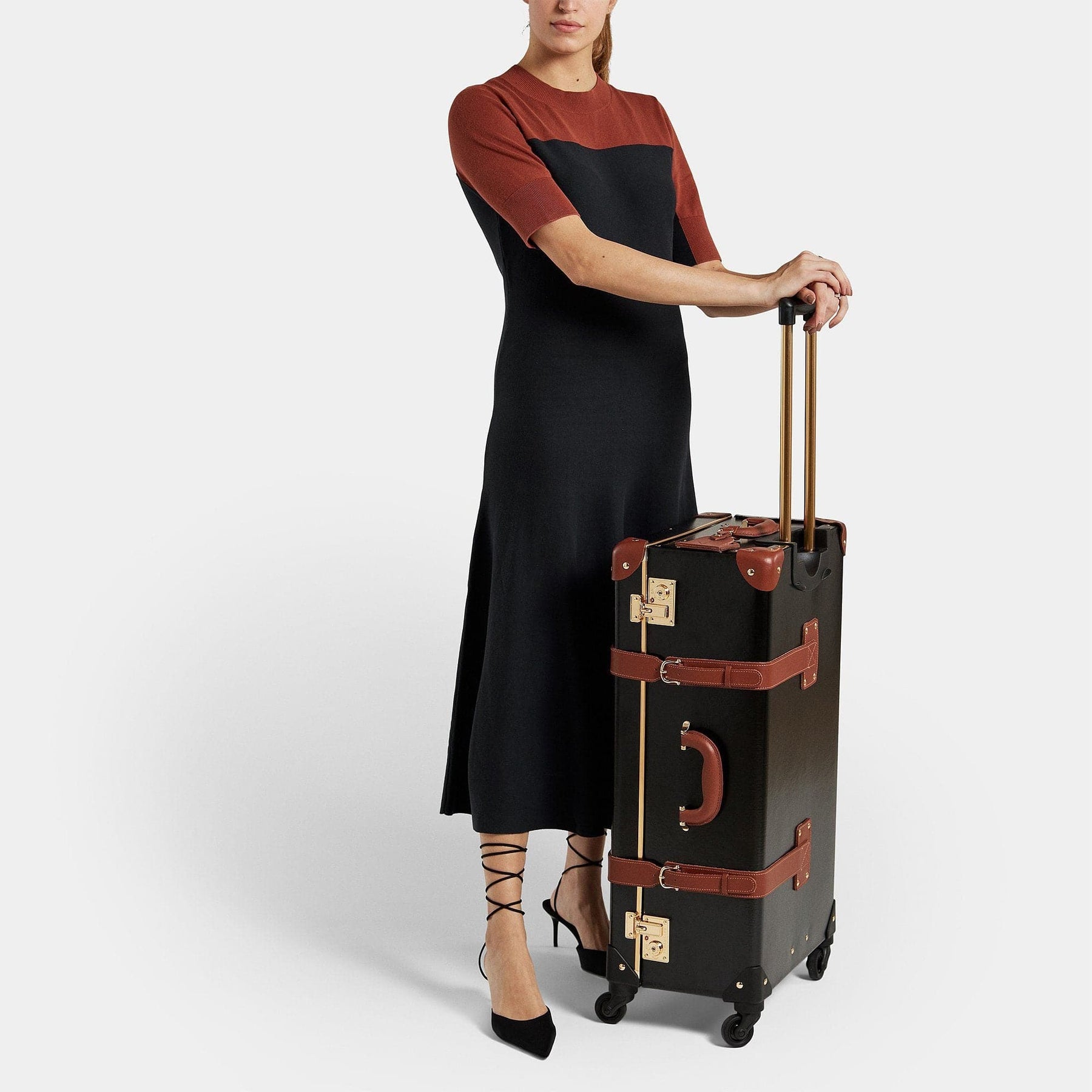 Model with the check-in Diplomat leather suitcase in black with raised handle