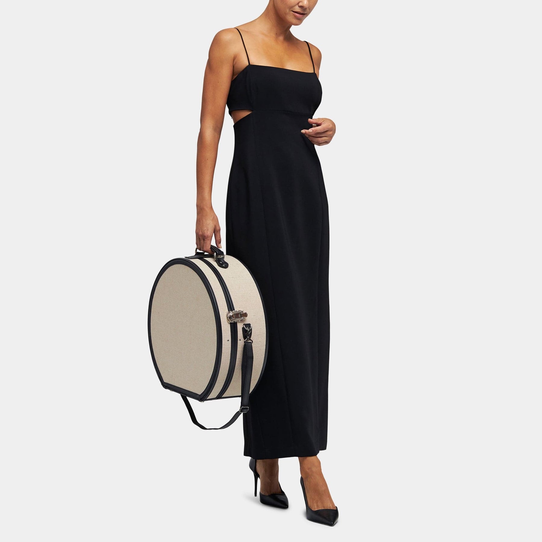 Model  with the deluxe hatbox Editor linen suitcase with black trims and shoulder attachment strap