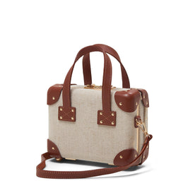 Angled product view of the mini Editor linen suitcase with brown trims and shoulder attachment strap