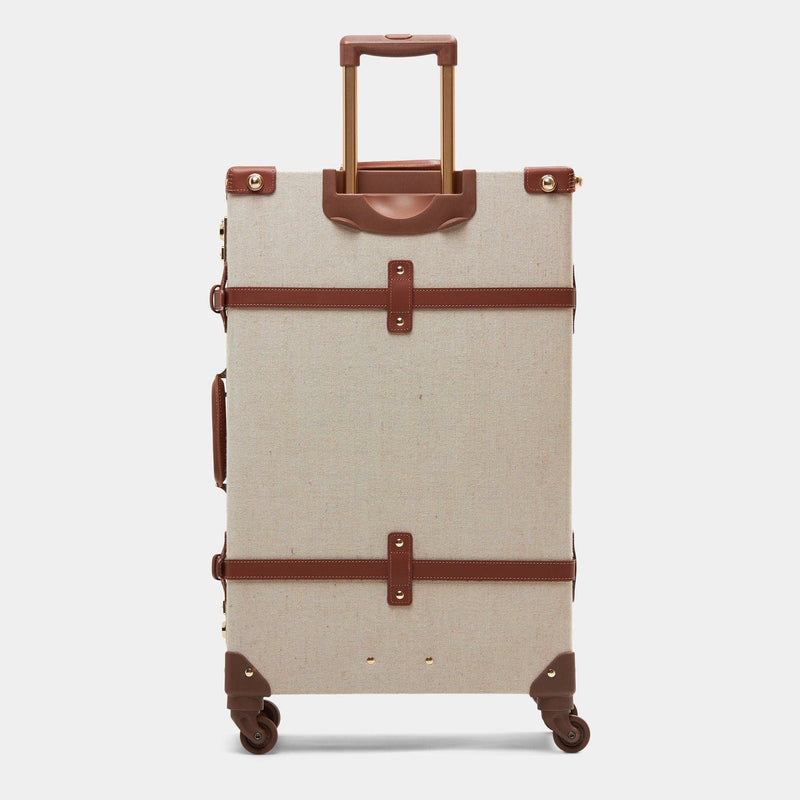 Back product view of the check-in spinner Editor linen suitcase with brown trims and raised handle