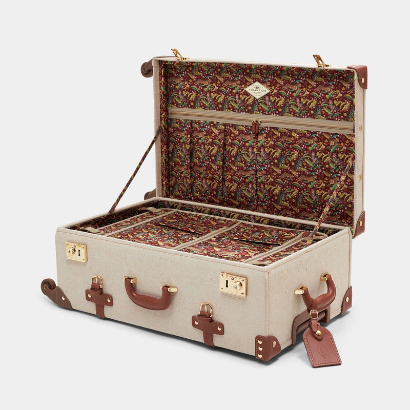 Open product view of the check-in spinner Editor linen suitcase with brown trims, exotic-bird print lining and leather luggage tag