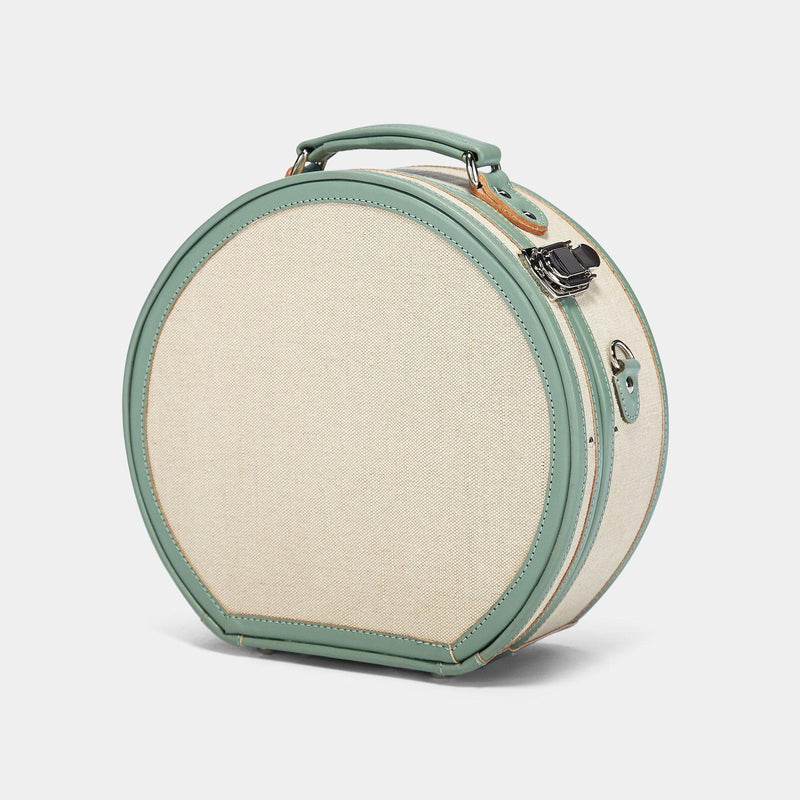 Angled product view of the small hatbox Editor linen suitcase with sea green trims