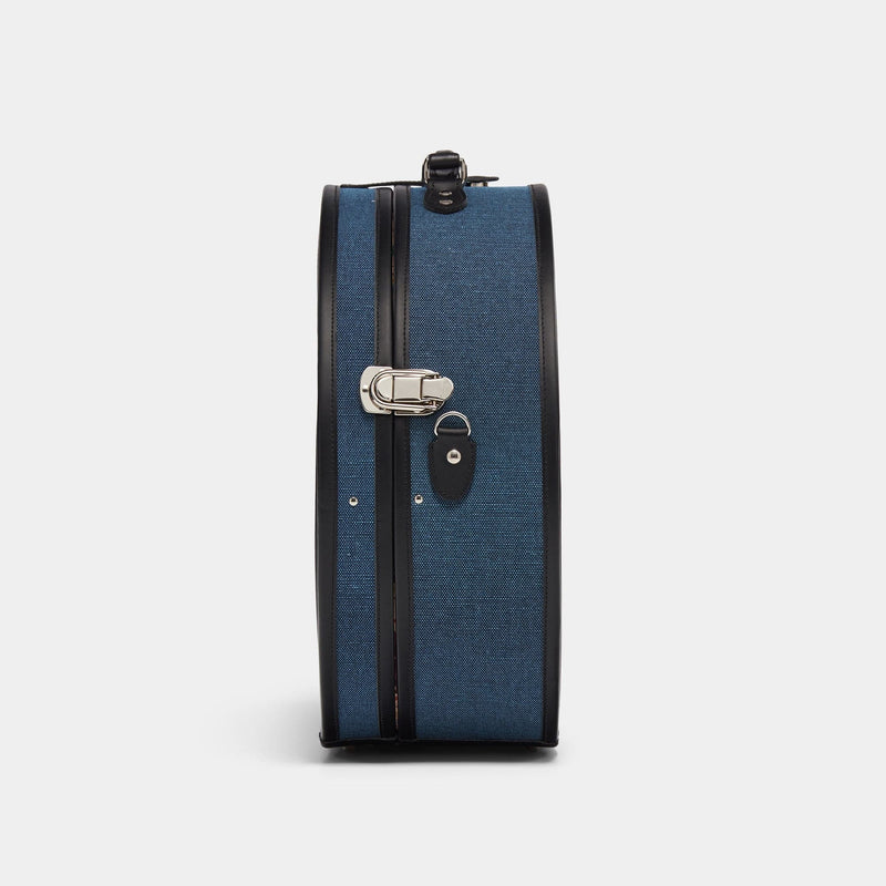 Side product view of the deluxe hatbox Editor linen suitcase with navy body and black trims