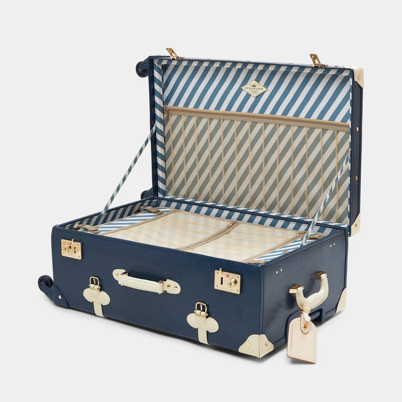 Open product view of the check-in spinner Entrepreneur vegan leather suitcase in navy with blue-white print lining and white vegan leather luggage tag