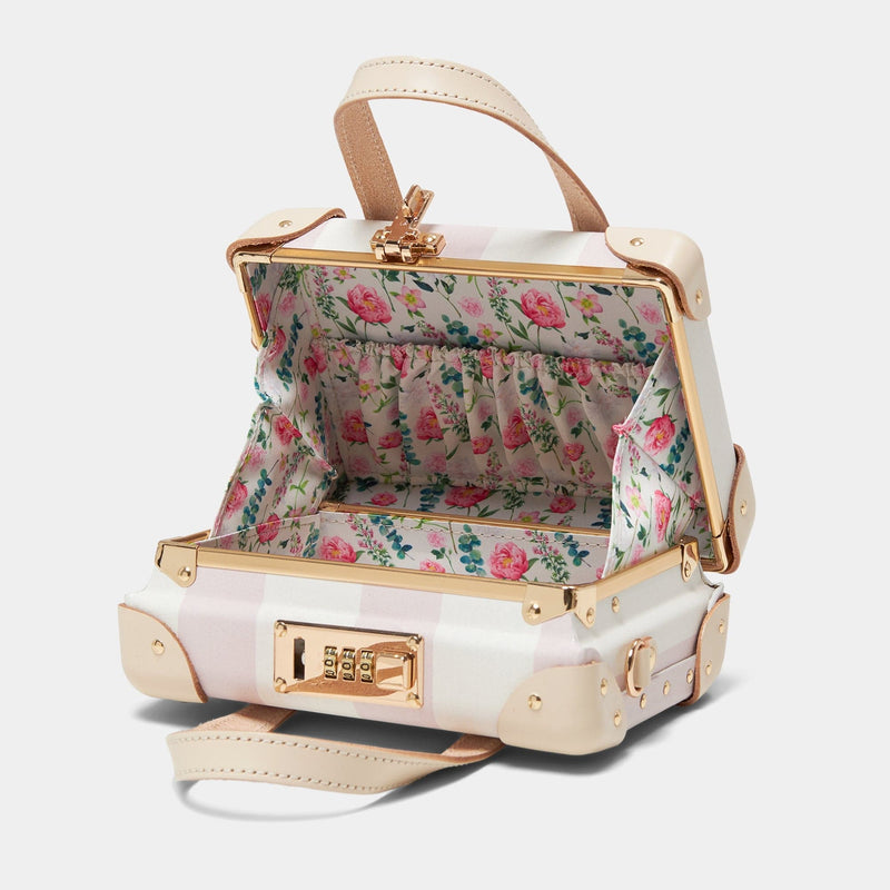 Open product view of the mini Illustrator fibreboard suitcase in pink-stripe with wildflower print lining