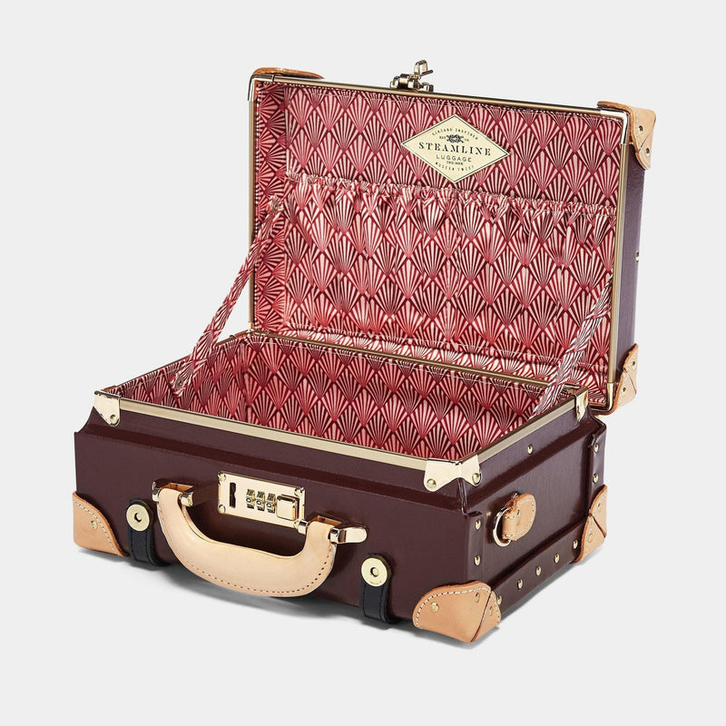 Open product view of the vanity Architect leather suitcase in burgundy with art-deco printed lining