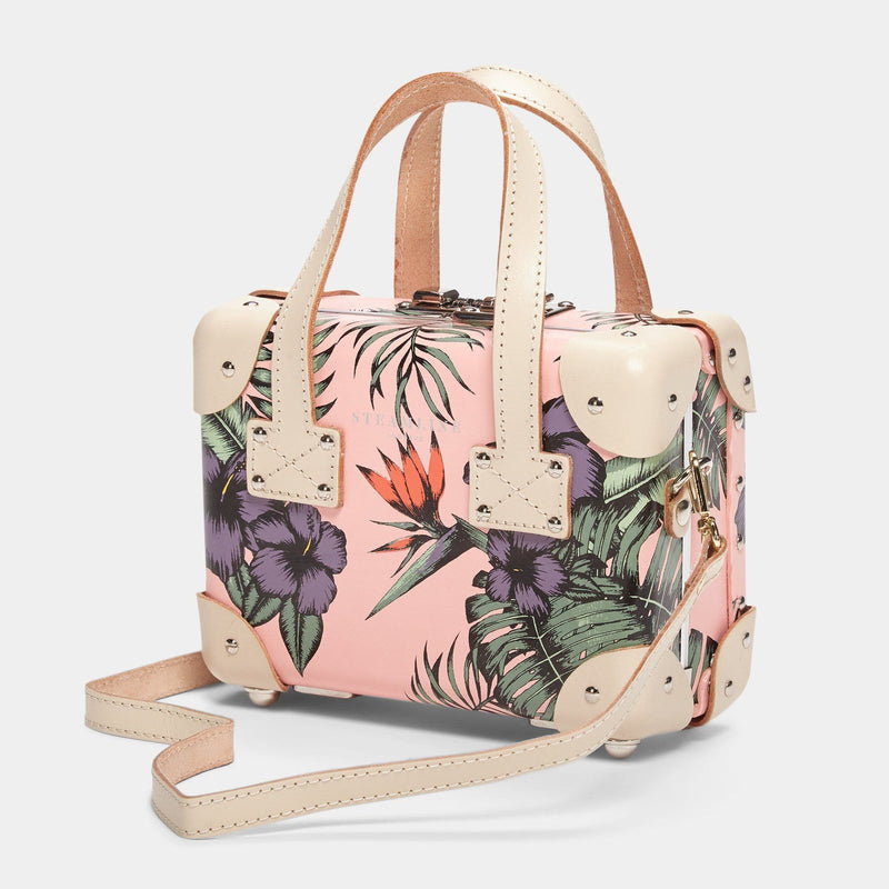 Angled product view of the mini Botanist fibreboard suitcase in pink with shoulder attachment strap