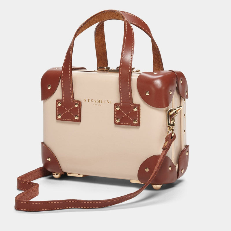Angled product view of the mini Diplomat leather suitcase in cream with shoulder attachment strap