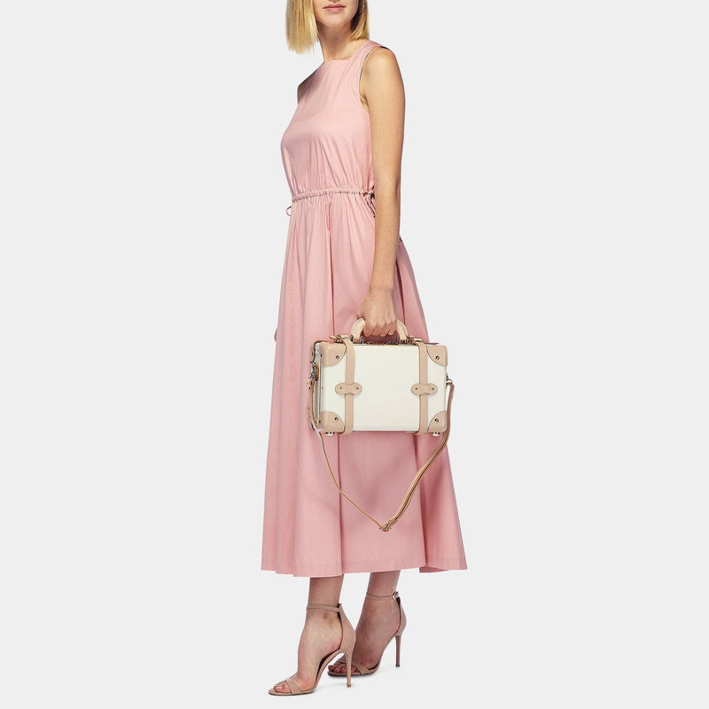 Model with the vanity Sweetheart fibreboard suitcase in cream with shoulder attachment strap