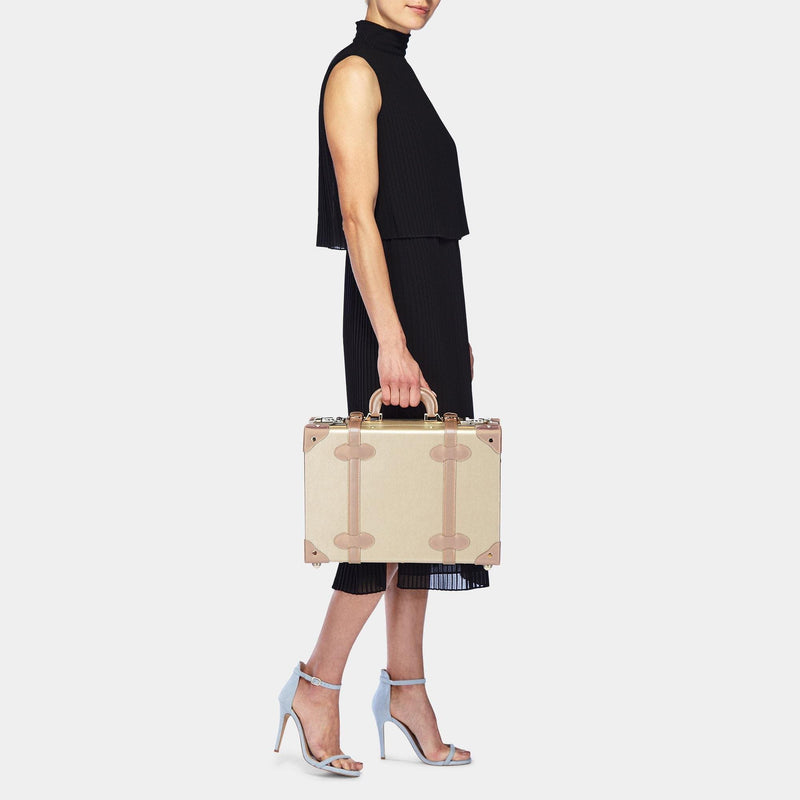 Model with the overnighter Alchemist vegan leather suitcase in gold