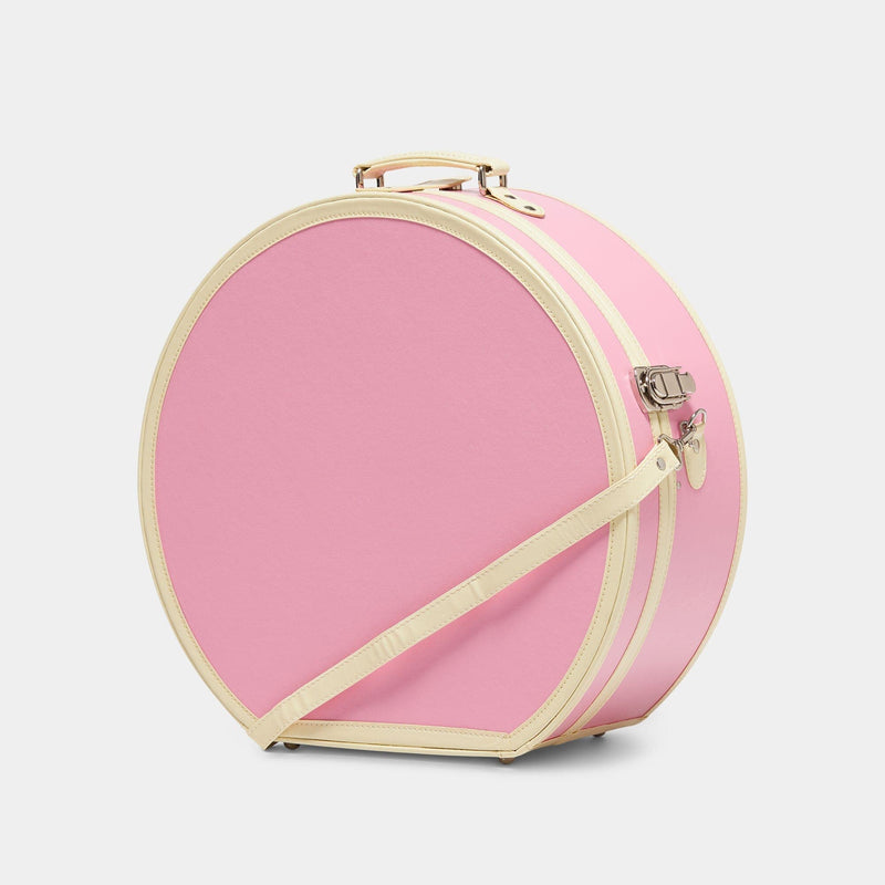 Angled product view of the deluxe hatbox Entrepreneur vegan leather suitcase in pink with shoulder attachment strap